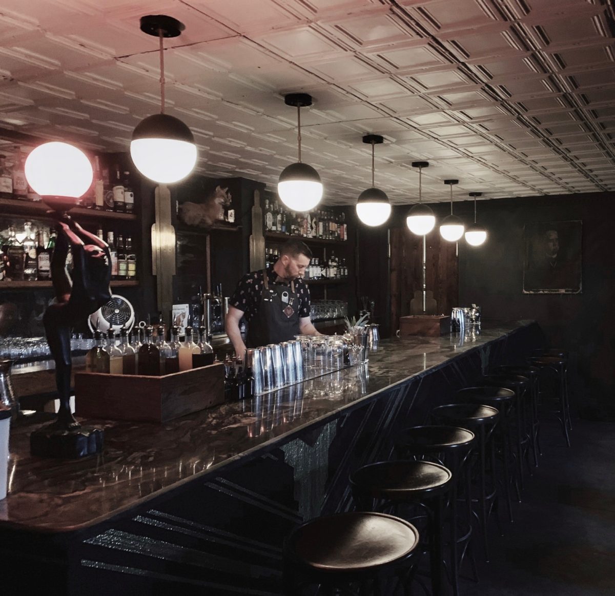 Bartender behind a bar.