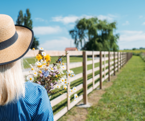 woman carrying flowers on a farm